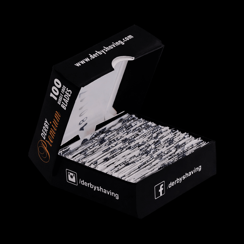 Box open of Derby Shaving blades with visible single white wrapping branding on a black background
