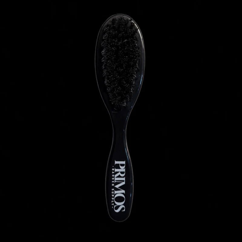 Black hairbrush with 'PRIMOS' branding on a black background