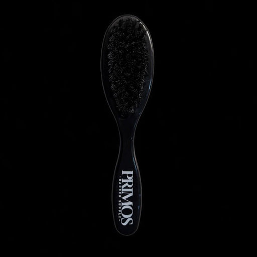 Black hairbrush with 'PRIMOS' branding on a black background