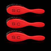 Three red Stylecraft brushes with black bristles and 'S/C' branding on a black background Primos Barber Supply