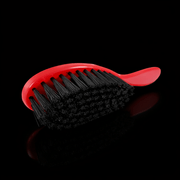 Red Stylecraft brush on a black background with slight shadow Primos Barber Supply