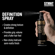 STMNT Grooming Goods Definition Spray being held with product details on a black background being sprayed Primos Barber Supply