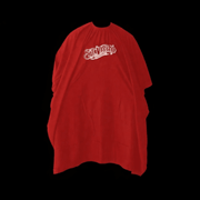 Red barber cape with 'Suavecito' logo on a black background Primos Barber Supply