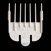 White Wahl hair clipper comb on a black background