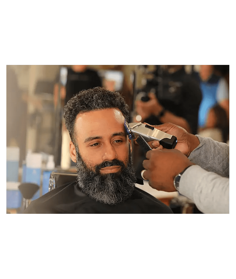 Andis Master Dual Magnet Comb Set – barber using guard on client in shop