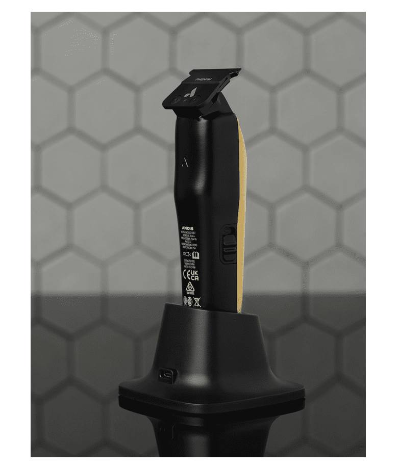 Black and gold hair trimmer on a stand with a geometric patterned background