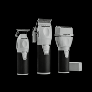Set of three BaBylissPRO hair clippers on a black background