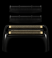 Black and gold electric shaver with interchangeable heads on a black background