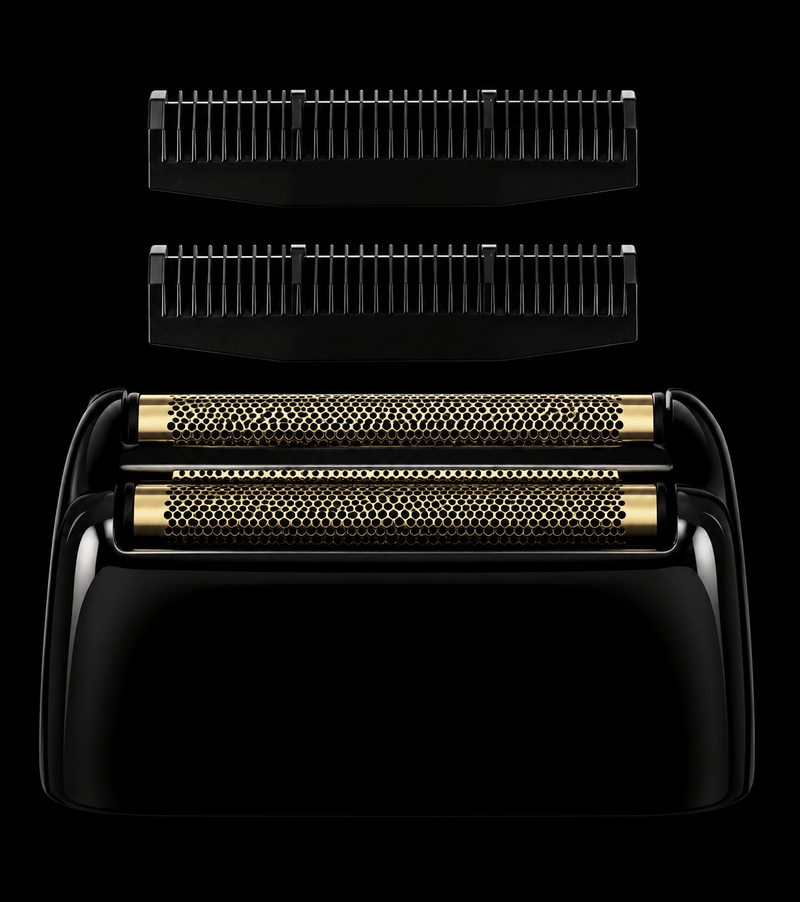 Black and gold electric shaver with interchangeable heads on a black background