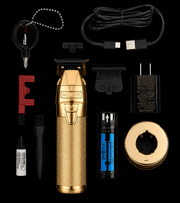 BaBylissPRO FXONE GoldFX Skeleton Trimmer FX799G – complete set with accessories on black background