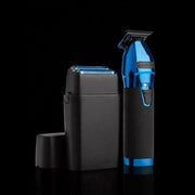 Blue and black grooming tool with charging station on a black background