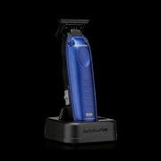 Blue BaBylissPro hair trimmer on a black stand with a clear background