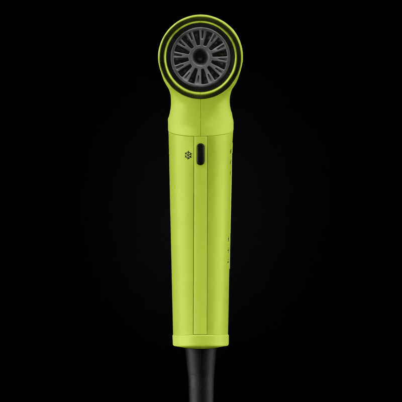 Yellow hair dryer with black nozzle on a black background