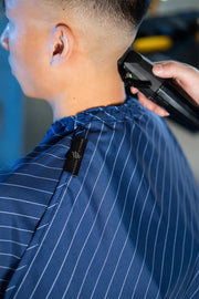 Barber strong Blue barber cape magnetic neck closure detail at primos barber supply