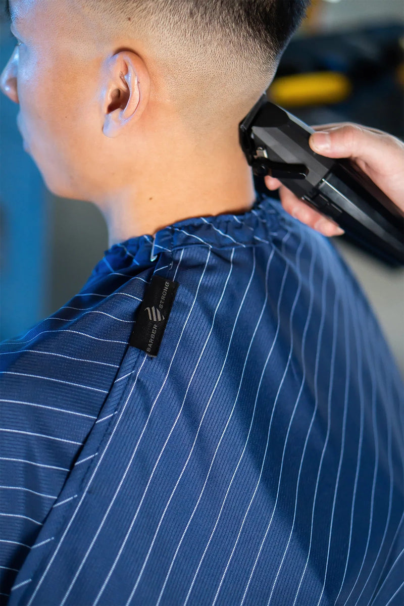 Barber strong Blue barber cape magnetic neck closure detail at primos barber supply