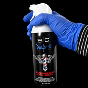 Barber using StyleCraft Duster X air spray to clean clippers and tools dust removal Primos Barber Supply