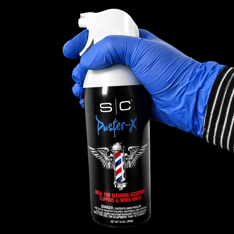 Barber using StyleCraft Duster X air spray to clean clippers and tools dust removal Primos Barber Supply