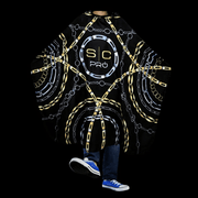 Barber cape worn on client black and gold professional haircut cape full coverage barber cape Primos Barber Supply