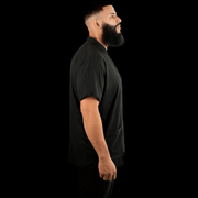 Black barber jacket side view breathable lightweight barber uniform for professionals Primos Barber Supply