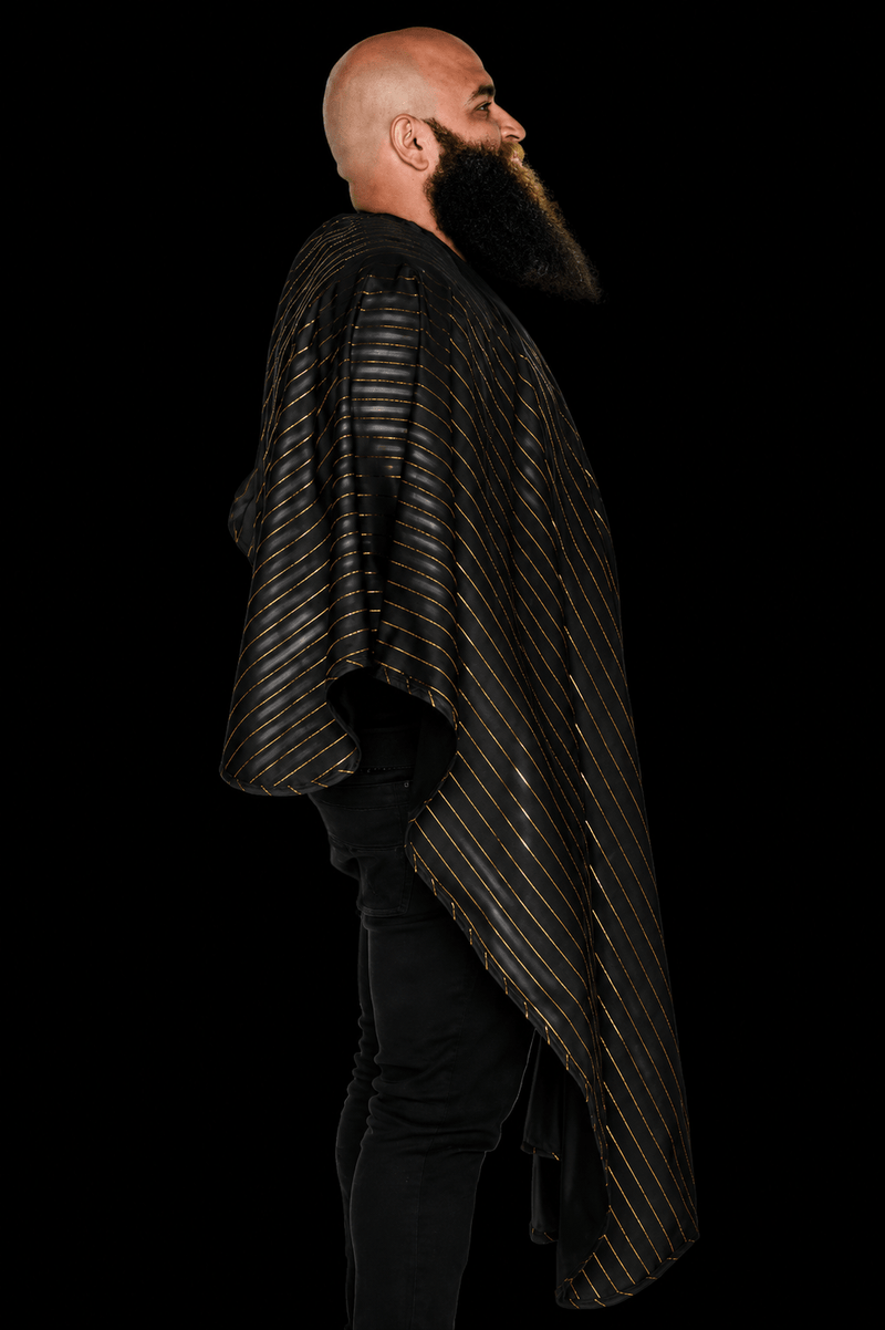 Barber Strong Shield Collection black barber cape with 24K gold pinstripes side profile view