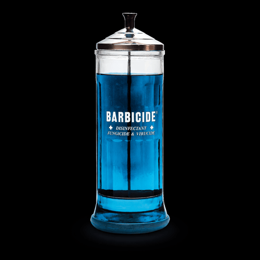 Barbicide Disinfectant Jar Large – filled with Barbicide solution on black background