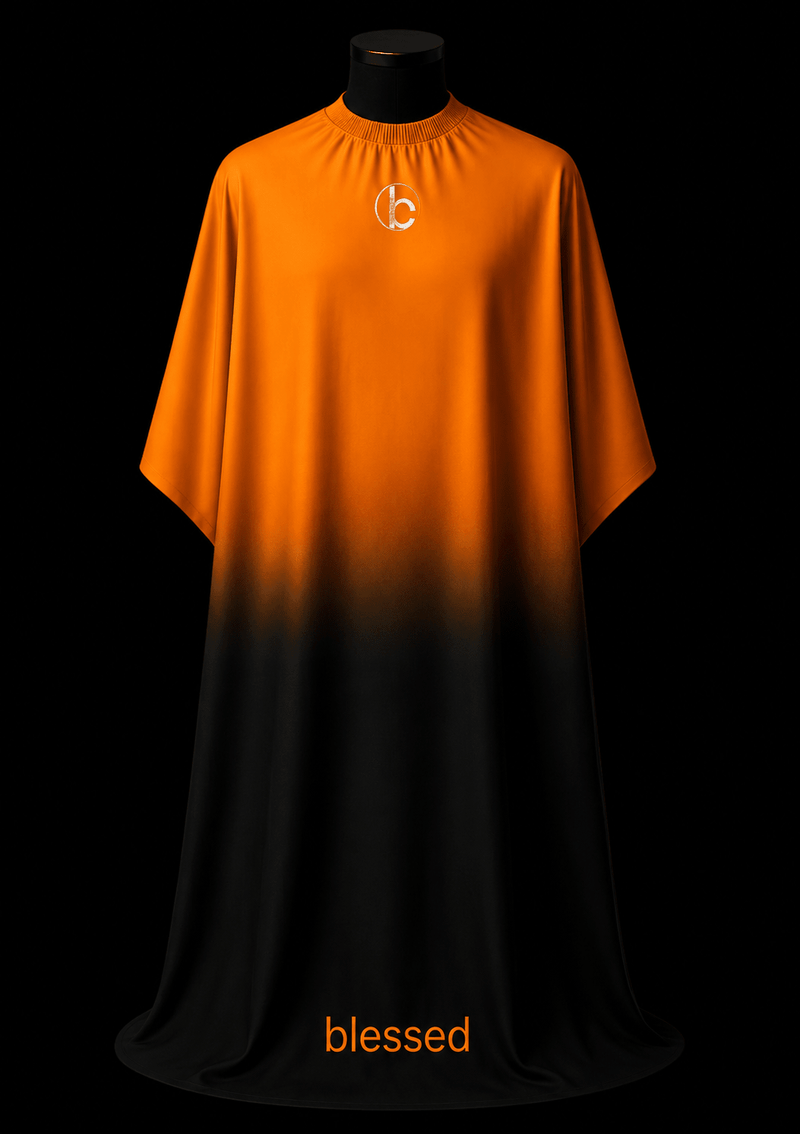 Blessed Capes Cinder barber cape featuring a bold orange to black gradient design, lightweight water-resistant material, and full professional coverage for barbers and stylists.