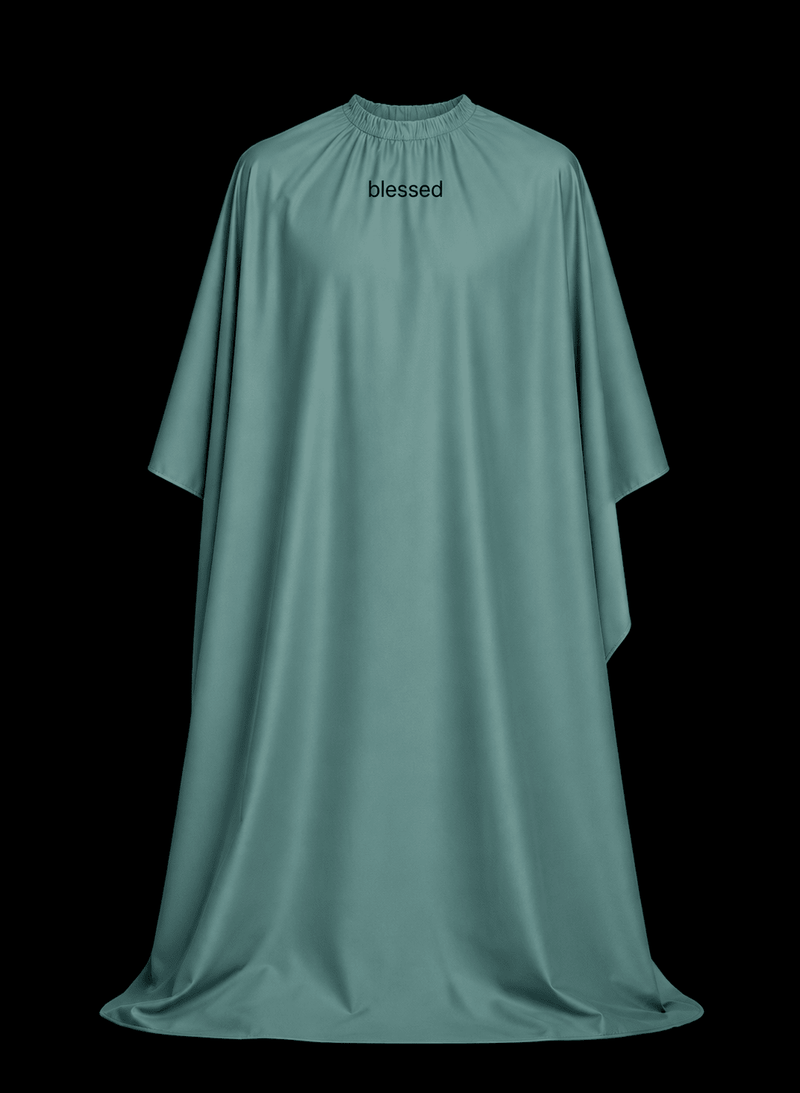 Blessed Capes Comet barber cape in a solid teal color featuring lightweight water-resistant material and full professional coverage for barbers and stylists.