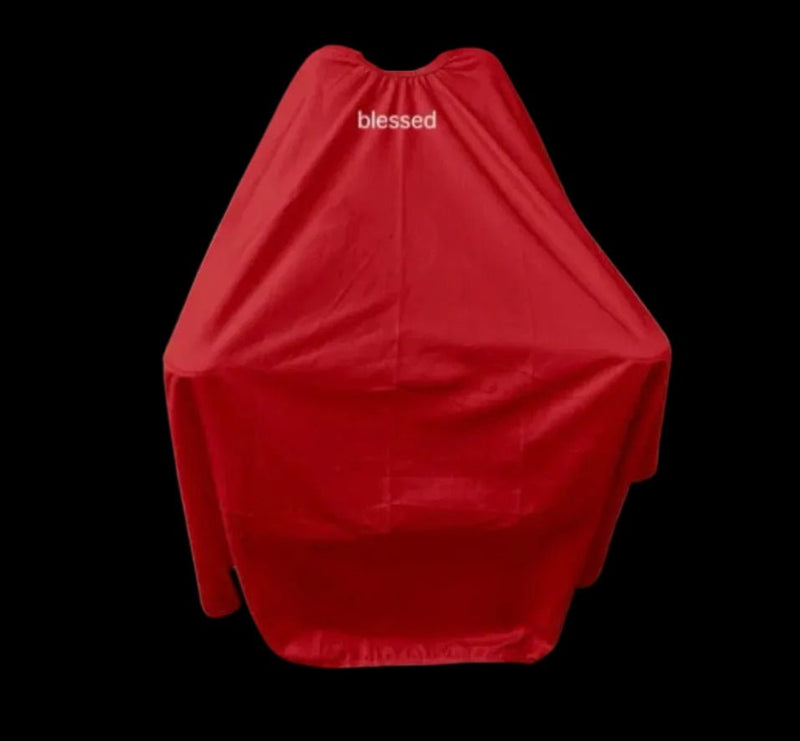 Blessed Capes Eclipse barber cape in red featuring a bold modern design, lightweight comfort, and professional full-coverage protection for barbers and stylists.