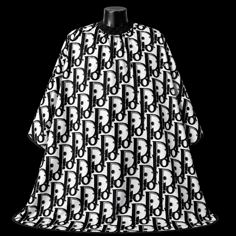 Dior Barber Cape - front-facing view showing the all-over black monogram lettering print on a white lightweight water-resistant polyester cape