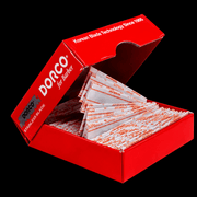 Red box of Dorco stainless blades with visible branding on a black background