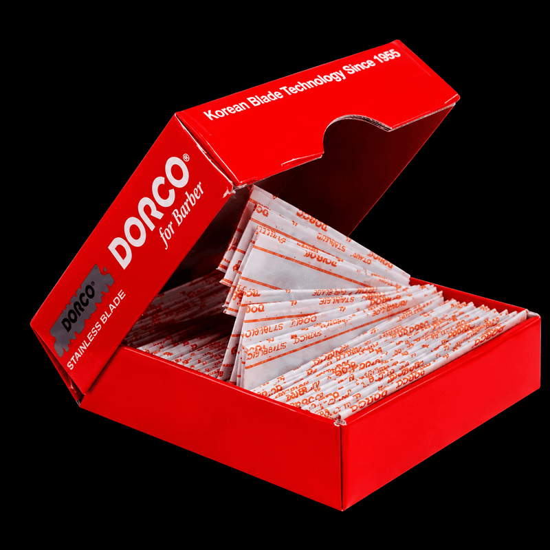 Red box of Dorco stainless blades with visible branding on a black background