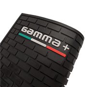 Close-up of a black textured product with 'gamma+' branding on a clear background