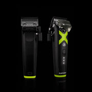 Two hair trimmers, one black and one black with green accents, on a black background.