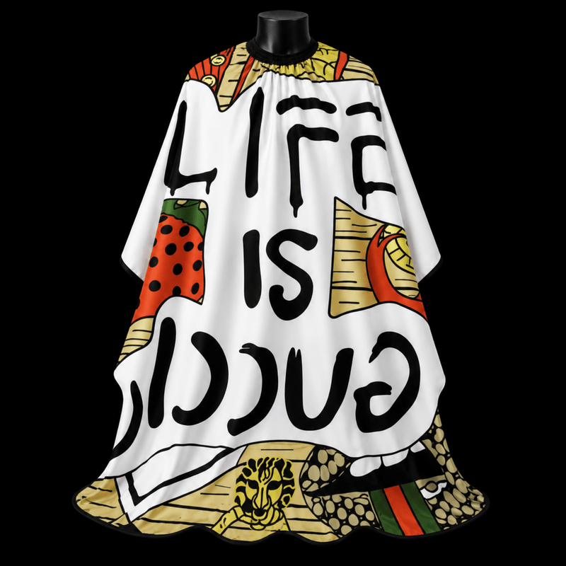 White Gucci Graphic Barber Cape - front-facing view showing the all-over Life Is Gucci graffiti print with gold snake and tiger motifs on a lightweight water-resistant polyester cape