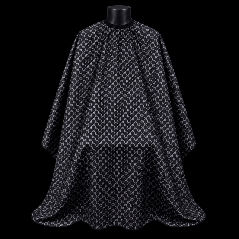 Black Gucci Barber Cape - front-facing view showing the all-over gray interlocking monogram print on a black lightweight water-resistant polyester cape