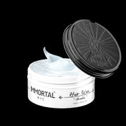Immortal NYC Aventus Hair Wax open jar with strong hold formula and high shine finish on black background
