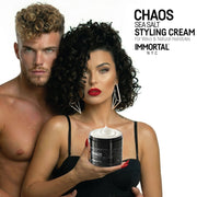 Couple with curly hair holding an open jar of Immortal NYC Chaos Sea Salt Curl Cream