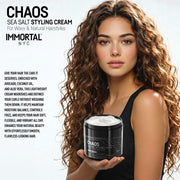 Woman with long curly hair holding Immortal NYC Chaos Sea Salt Curl Cream