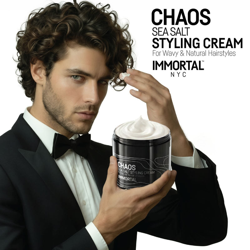 Man with curly hair scooping Immortal NYC Chaos Sea Salt Curl Cream from the jar