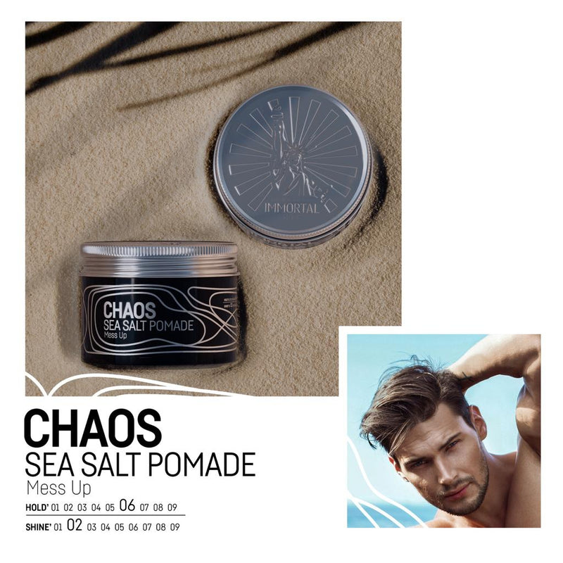 Immortal NYC Chaos Sea Salt Pomade open jar on sand showing hold 6 of 9 and shine 2 of 9