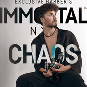 Man with curly hair holding jars of Immortal NYC Chaos Sea Salt Pomade