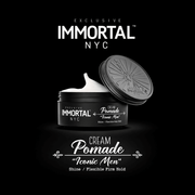 Immortal NYC Cream Pomade jar with open lid with expanded label wording on a black background