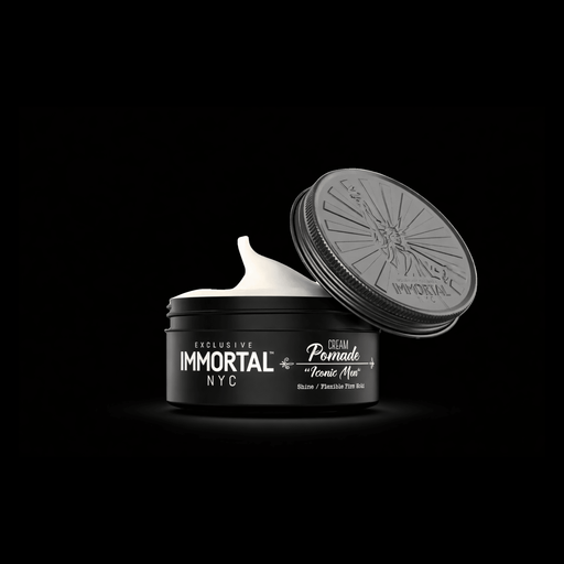 Open jar of Immortal NYC cream pomade with black lid on a black background