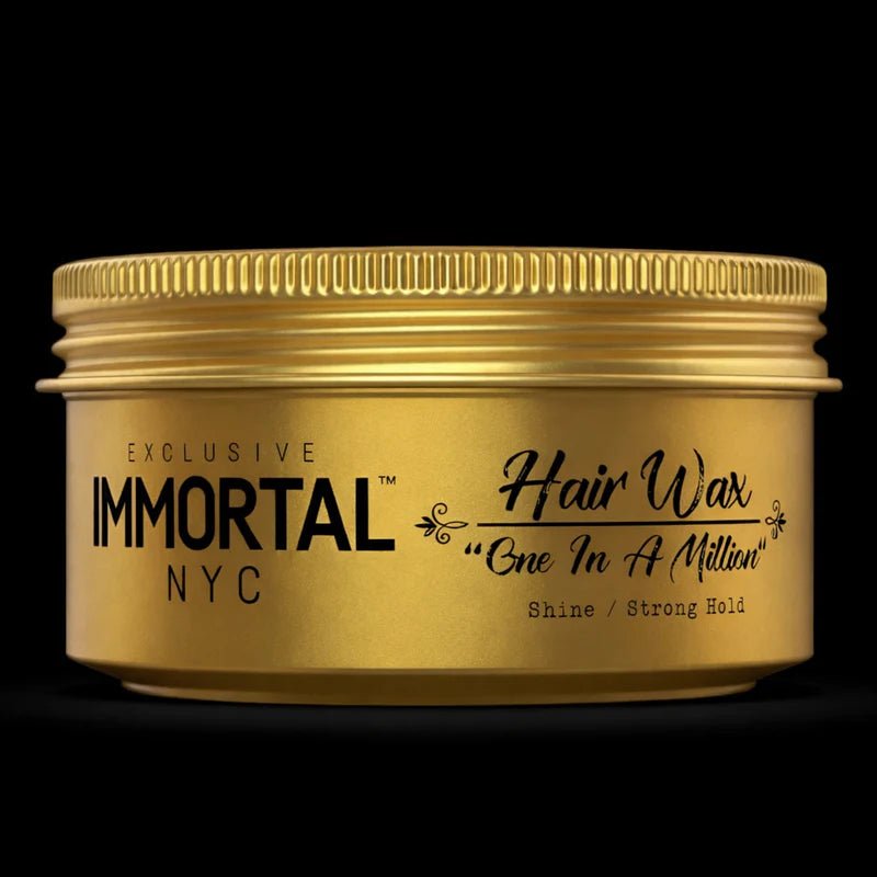 Gold jar of Immortal NYC hair wax on a black background