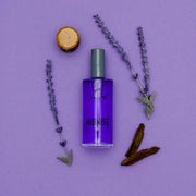 Purple perfume bottle labeled 'Midnite' with lavender sprigs on a purple background
