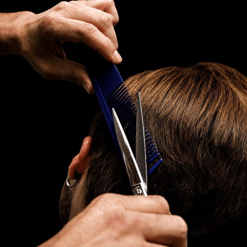 Johnny B Texturizing Comb Blue – in use for professional hair cutting and styling
