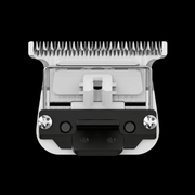 Hair clipper head with comb attachment on a black background