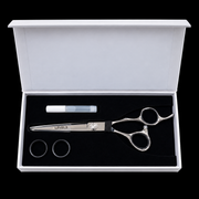 L3VEL3 Professional Hair Cutting Shears 440C - overhead view of the presentation case with shear, oil bottle, and spare finger-sizing rings