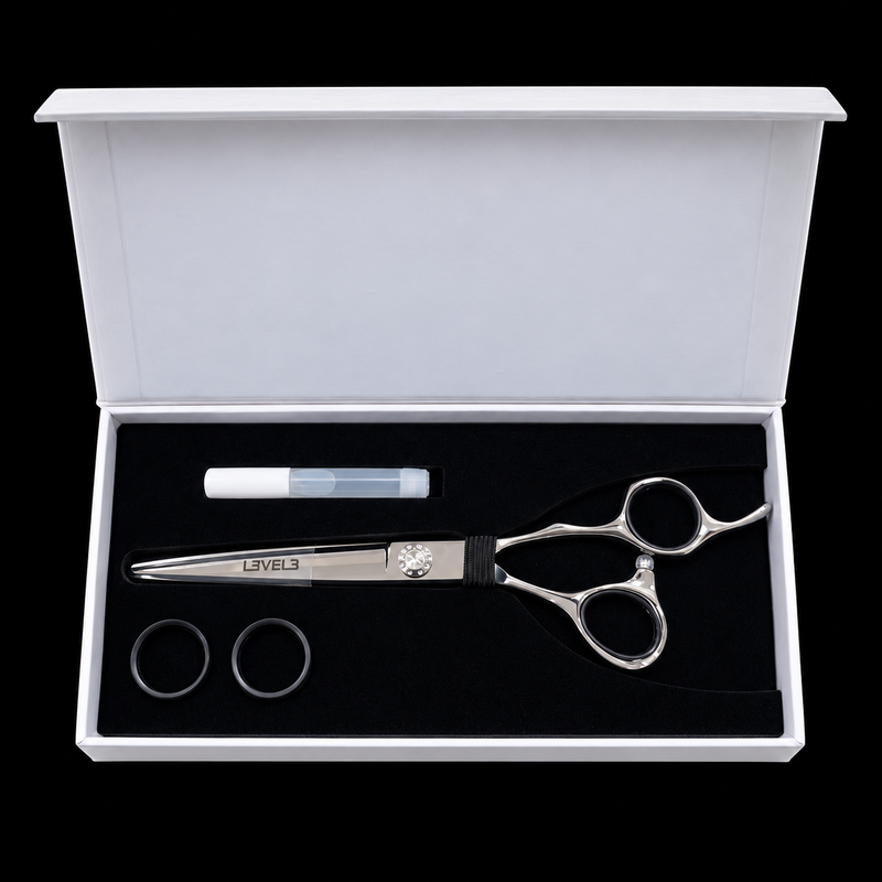 L3VEL3 Professional Hair Cutting Shears 440C - overhead view of the presentation case with shear, oil bottle, and spare finger-sizing rings