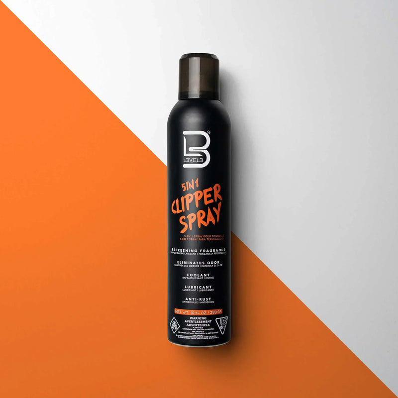 Black bottle of 5-in-1 clipper spray on a white and orange background